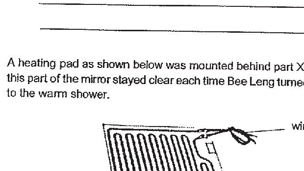 A diagram of a heating pad with coiled heating elements and a wire attached. The heating pad is shown to be mounted behind part X of the mirror to keep it clear.